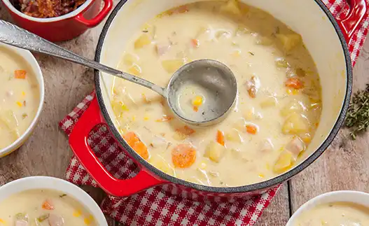 red pot of cheese and corn chowder