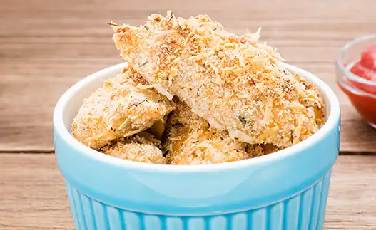 a light blue bowl with chicken nuggets