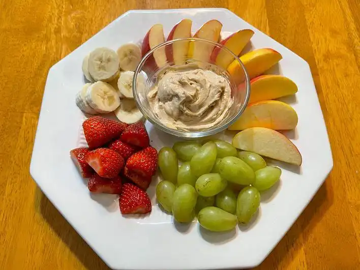 platter of fruit dip with fruits surrounding it