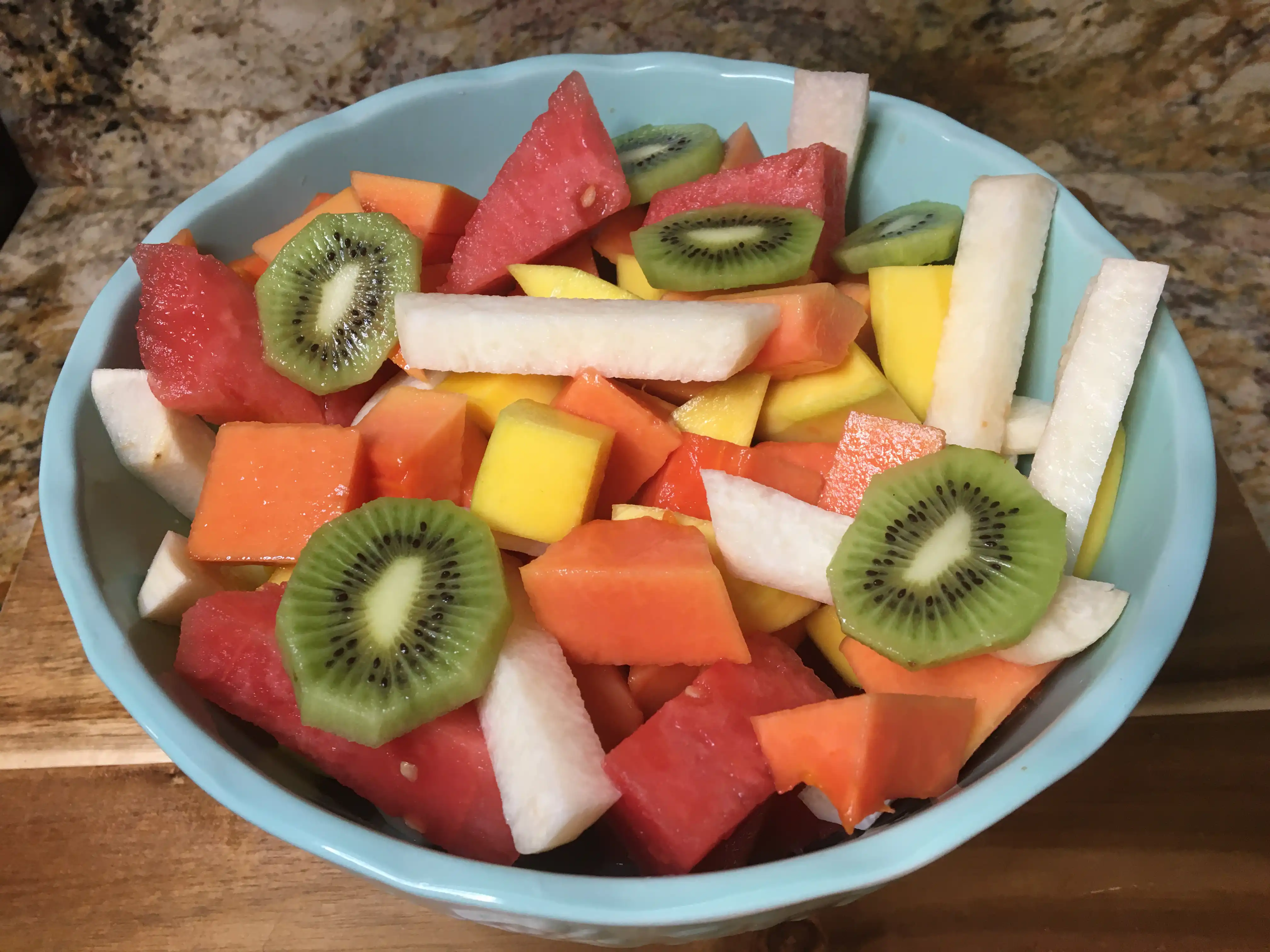fruit salad in a bowl with jicama and kiwi