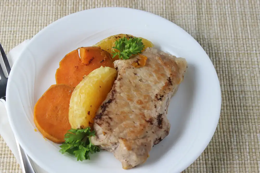 white plate with orange pork chops