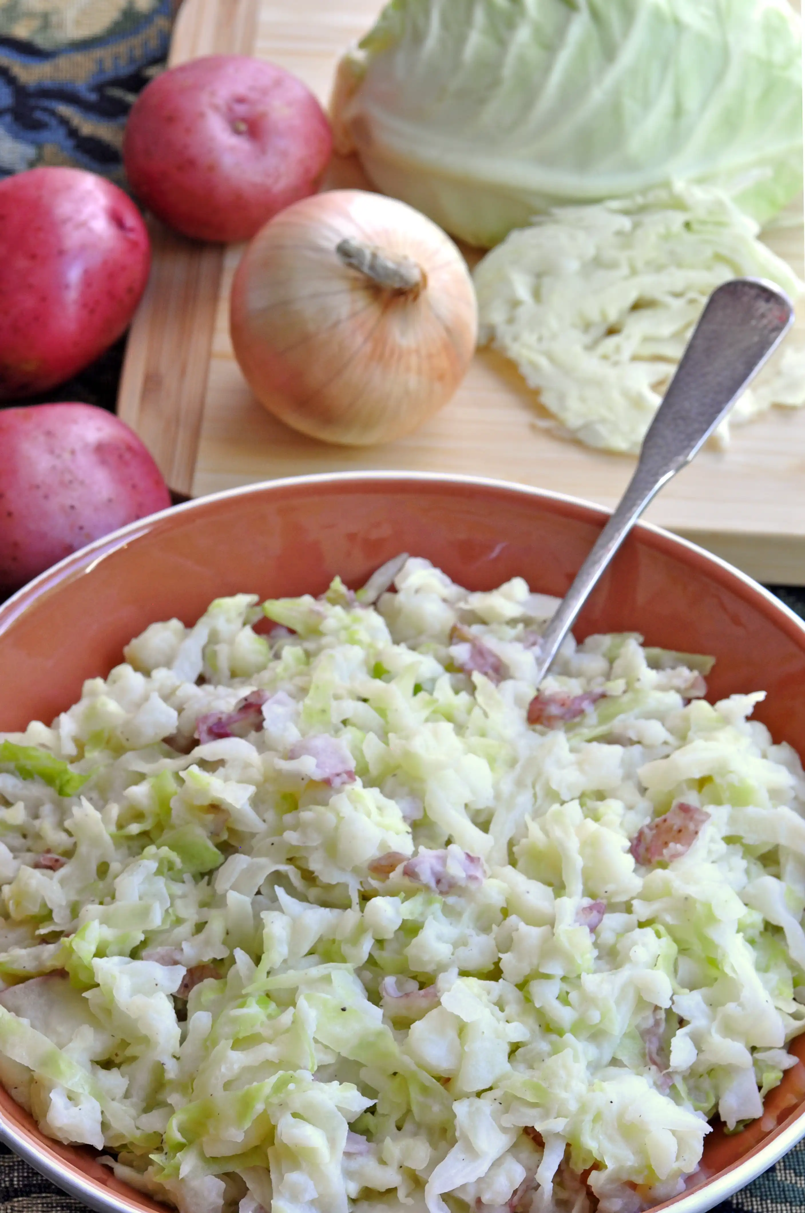 a bowl of red potatoes and cabbage