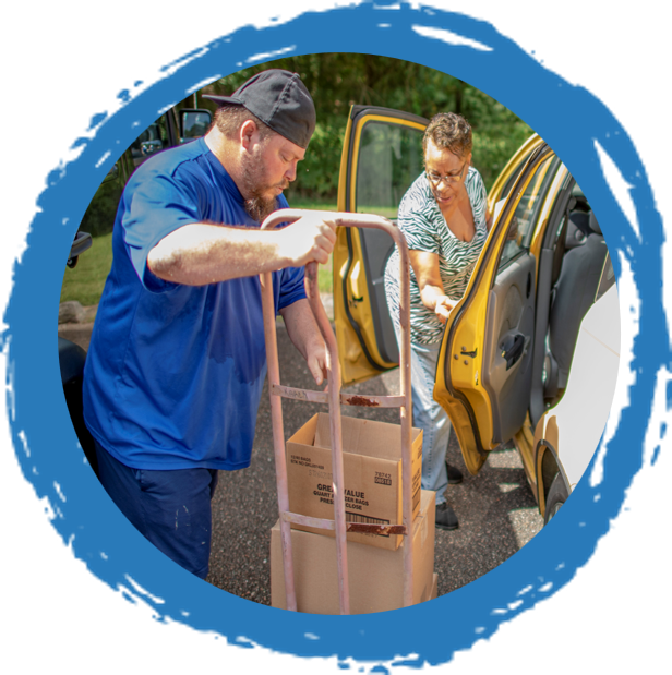 csfp food delivery into woman's car using a dolly on a blue paintbrush circle background