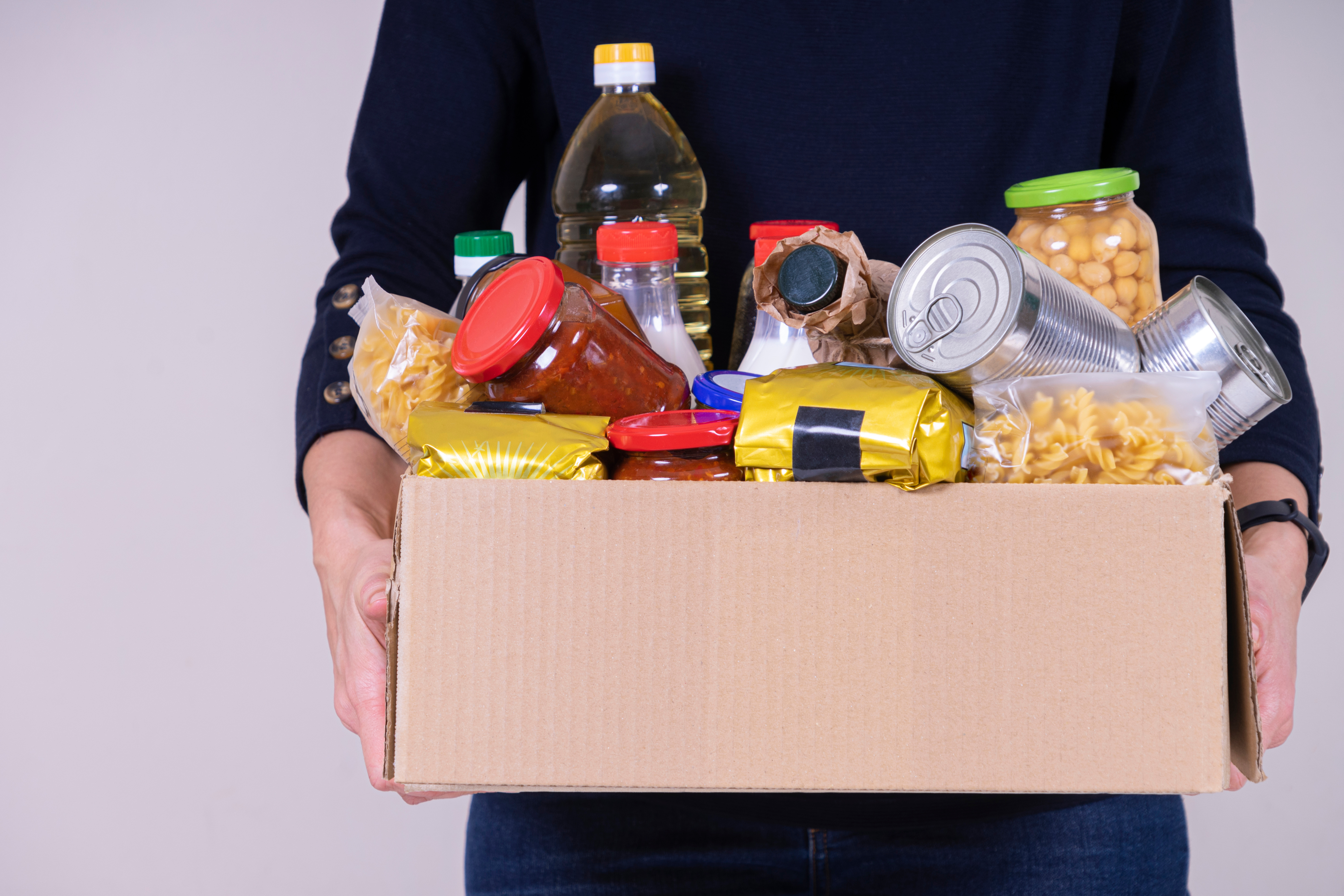 Person holding box of food