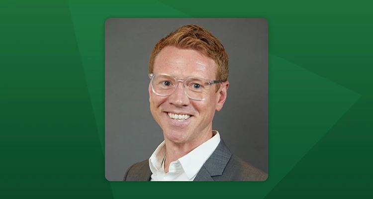 headshot of Andrew on a green background