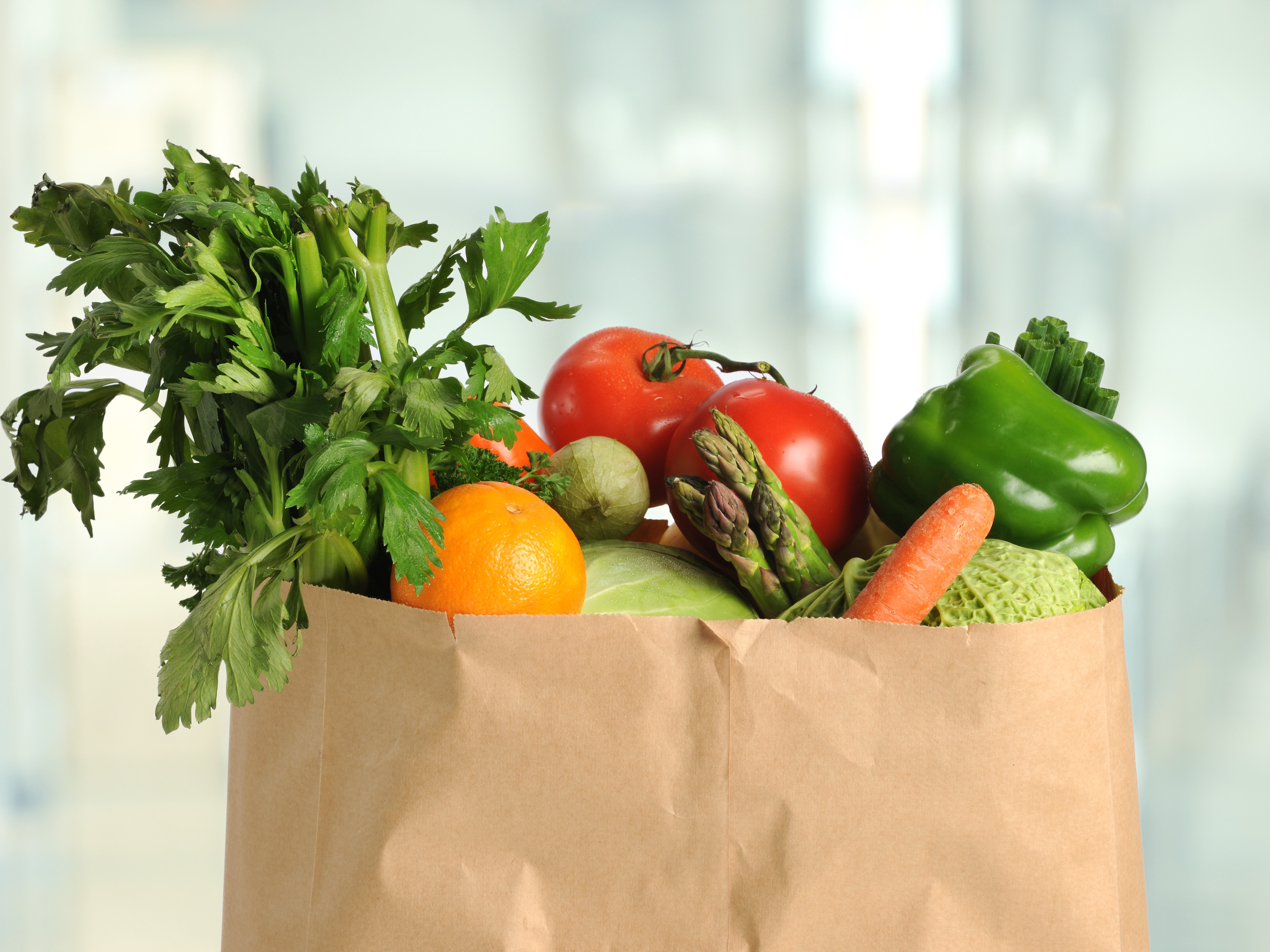 paper grocery bag of veggies