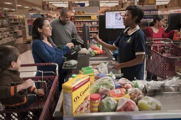 family checking out at a grocery store