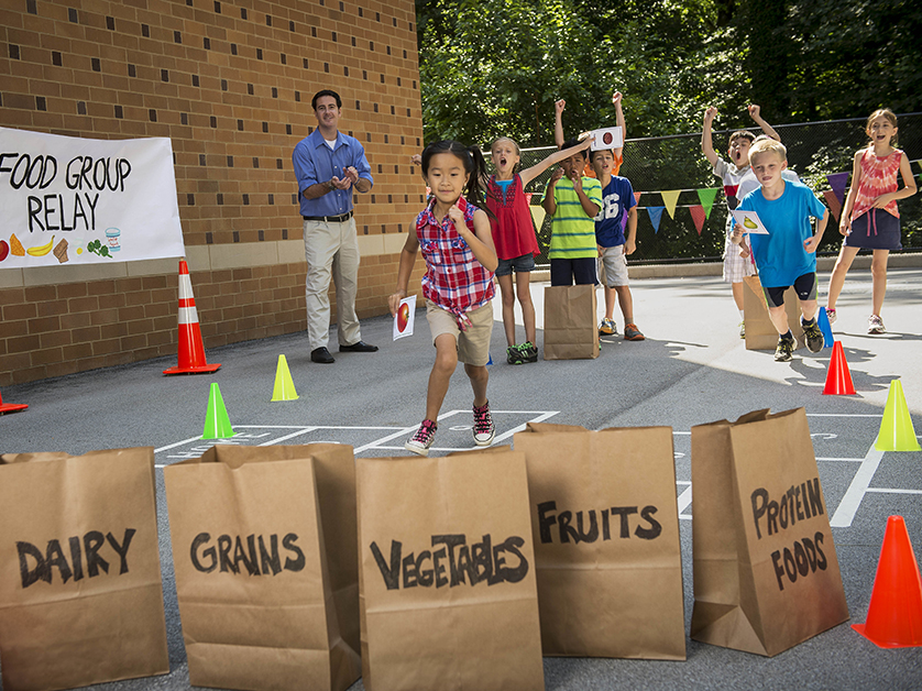 kids running in an outdoor relay race at school
