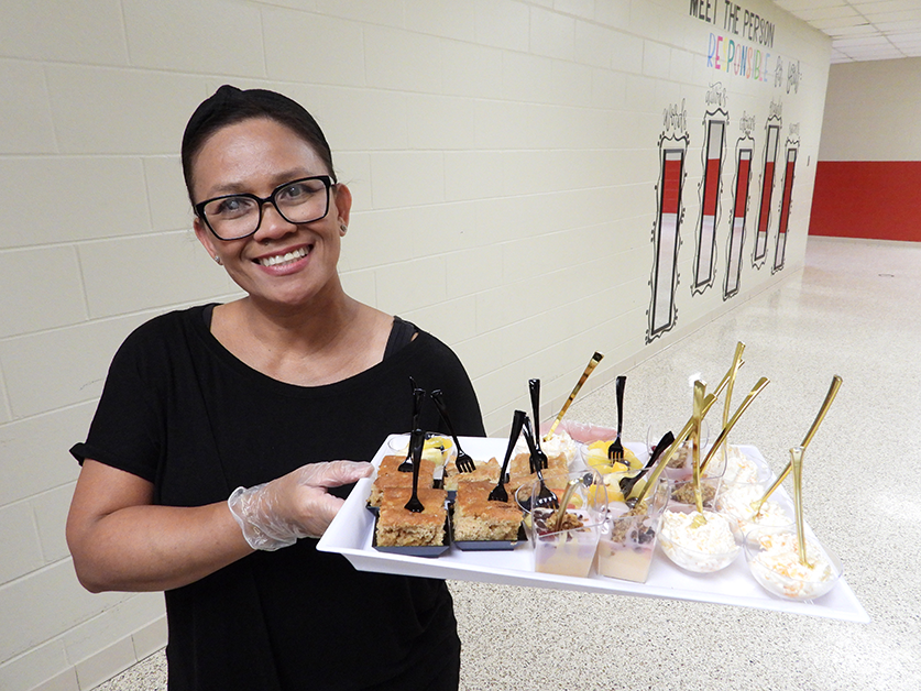 school nutrition professional holding a tray of samples