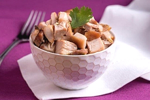 Bowl with cubes of baked chicken