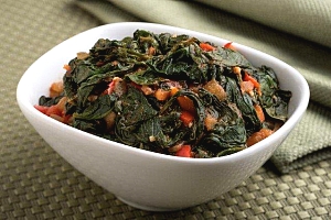 dish of sauteed spinach with tomatoes