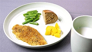 image of a plate with baked tilapia, green beans, and a glass of milk on the side