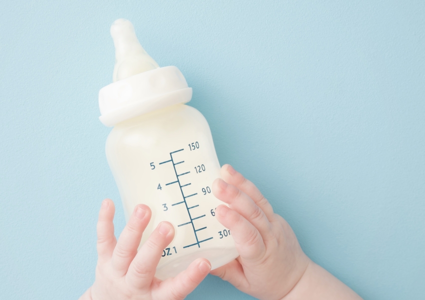 baby hands holding bottle