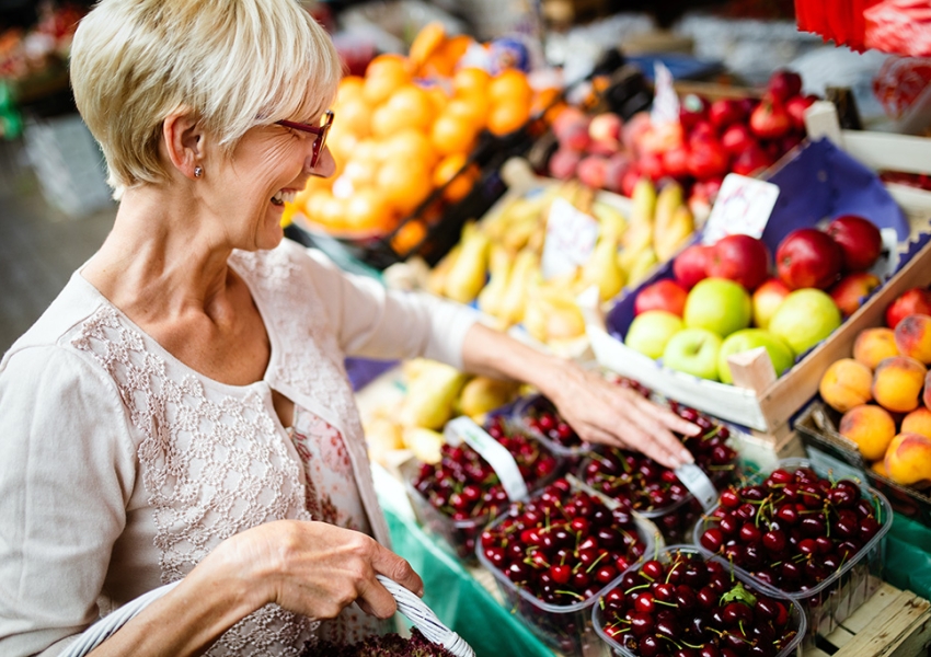 woman shopping at a produce stand