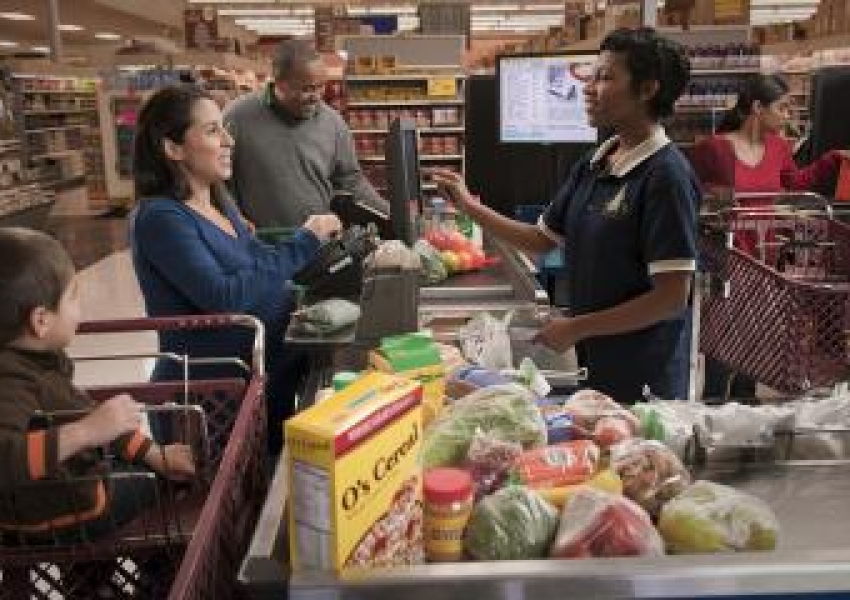 family checking out at a grocery store