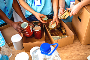People packing boxes with food