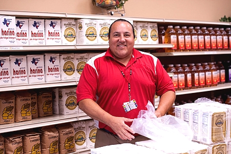 FDPIR tribal operator stocking shelves in a grocery store distribution model