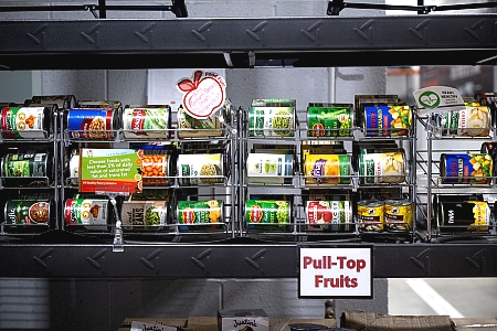 a shelf of canned fruits with a label "pull-top fruits"