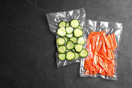 vacuum sealed bags of chopped cucumbers and carrots.